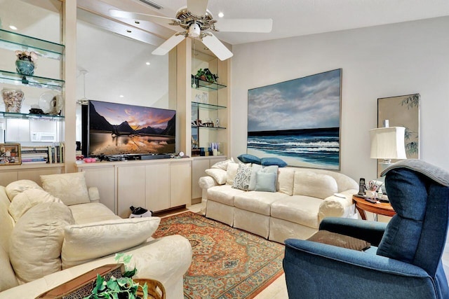 living room with light wood-type flooring, ceiling fan, and lofted ceiling