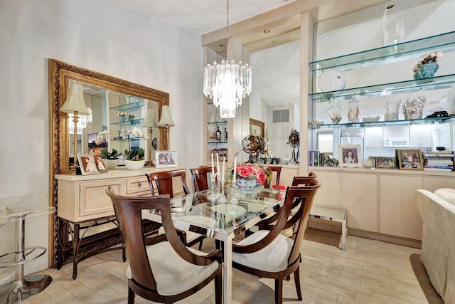 dining space with an inviting chandelier and light wood-type flooring