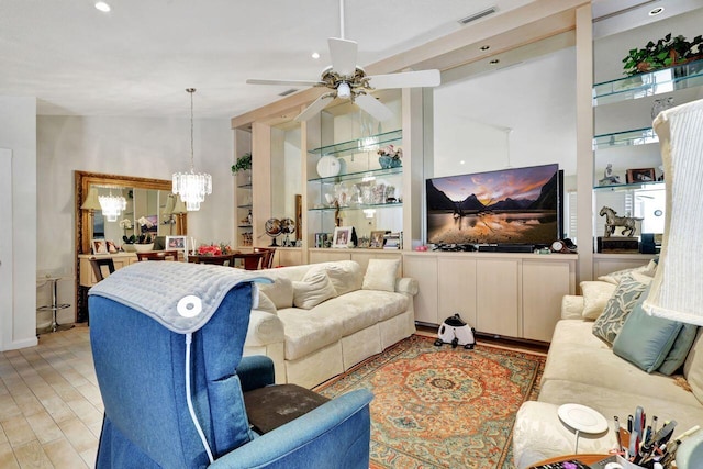 living room with ceiling fan with notable chandelier and light wood-type flooring