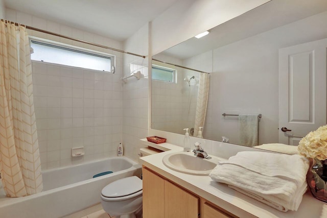 full bathroom with vanity, shower / tub combo, and toilet