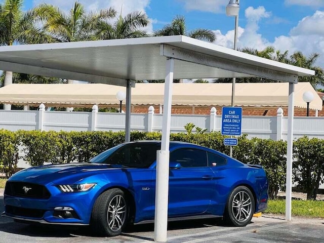 view of vehicle parking with a carport