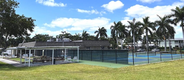 view of tennis court with a lawn