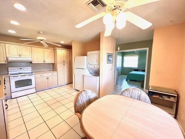 kitchen with ceiling fan, white appliances, a textured ceiling, and light tile patterned floors