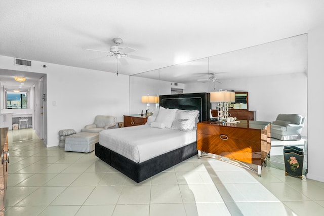 bedroom with ceiling fan and light tile floors