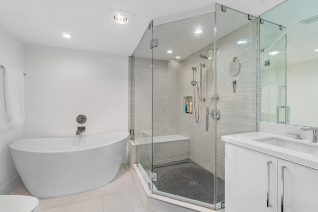 full bathroom with oversized vanity, shower with separate bathtub, toilet, and tile flooring