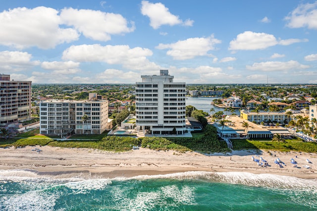 view of property with a view of the beach and a water view