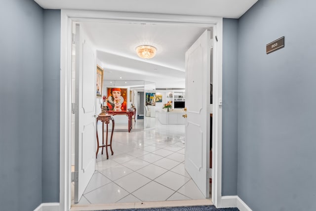 hall featuring light tile floors