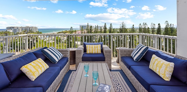 balcony featuring an outdoor living space and a water view