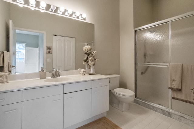 bathroom featuring vanity, walk in shower, tile patterned flooring, and toilet