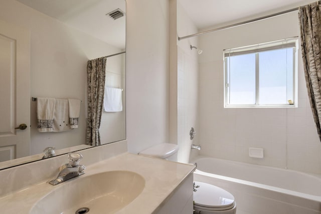 full bathroom featuring toilet, shower / bath combo, and vanity