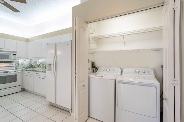 laundry room with a textured ceiling, washing machine and dryer, ceiling fan, and light tile patterned flooring