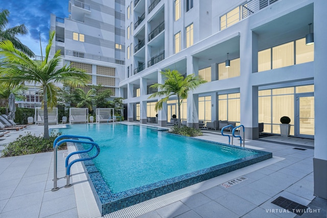 community pool with a patio area