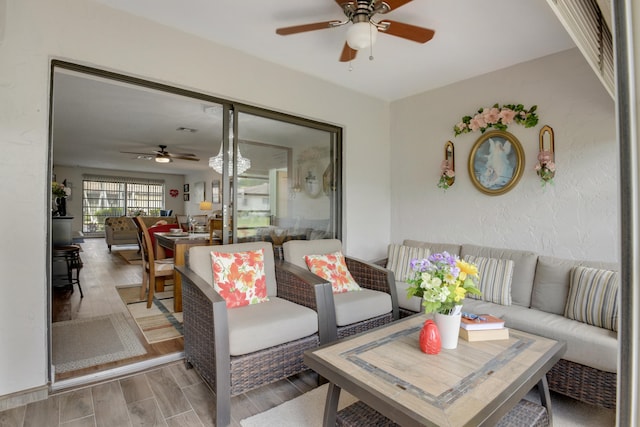 living room with ceiling fan and hardwood / wood-style floors