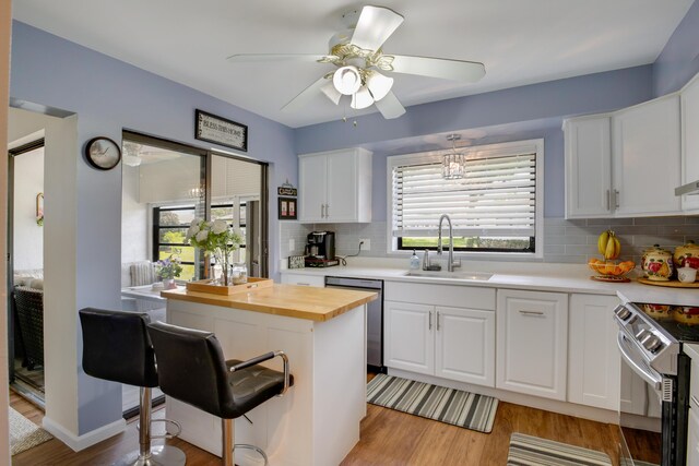 kitchen with white cabinets, backsplash, and sink