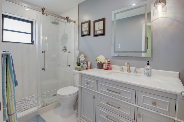 bathroom with vanity, toilet, and an enclosed shower