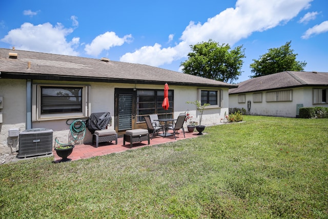 back of house with a lawn, a patio area, and central air condition unit