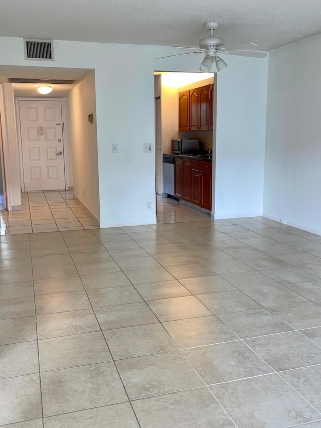 tiled spare room featuring ceiling fan and a textured ceiling