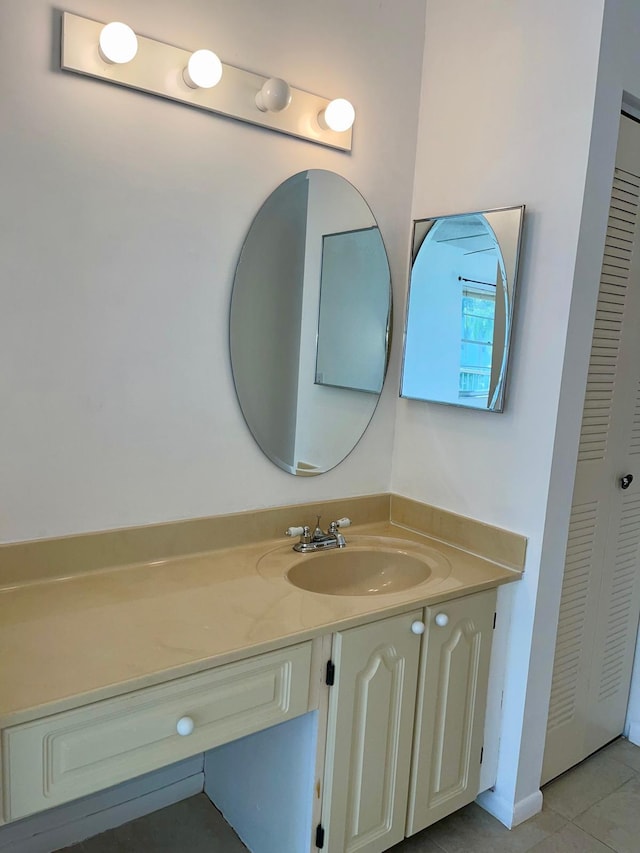 bathroom featuring tile patterned flooring and vanity