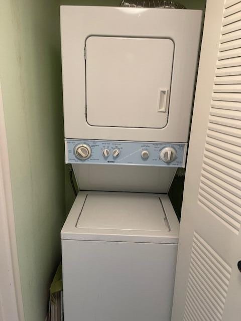 laundry room with stacked washing maching and dryer