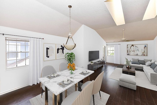 dining area featuring a textured ceiling, dark wood-type flooring, ceiling fan, and lofted ceiling