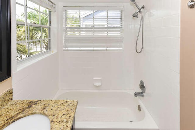 bathroom featuring vanity and tiled shower / bath combo