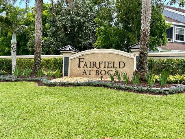 community sign featuring a lawn