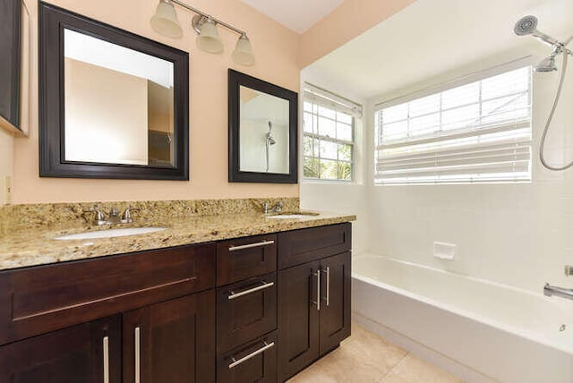 bathroom with tile patterned flooring, vanity, and  shower combination