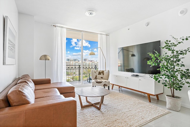 living room featuring expansive windows and tile patterned flooring