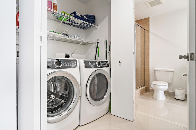 clothes washing area featuring separate washer and dryer and light tile patterned flooring