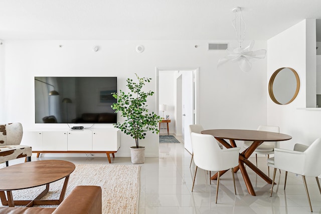 living room with ceiling fan and light tile patterned floors