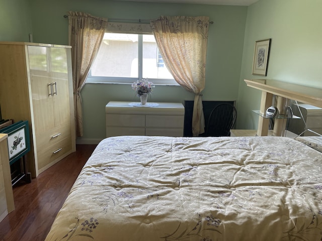 bedroom featuring dark hardwood / wood-style flooring