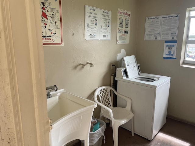 washroom with washer / clothes dryer and sink