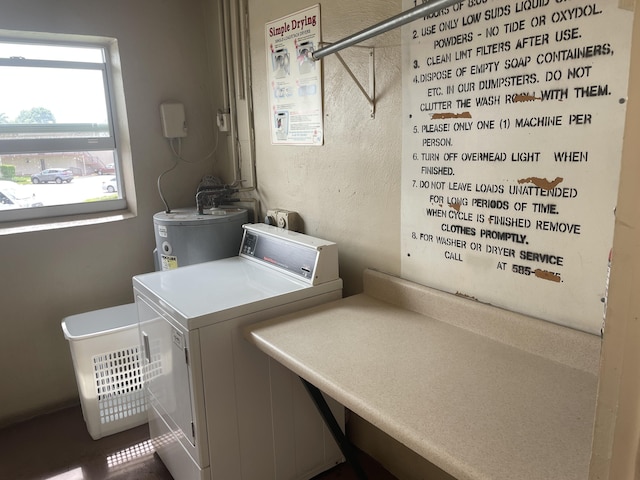 laundry area with electric water heater and washing machine and dryer