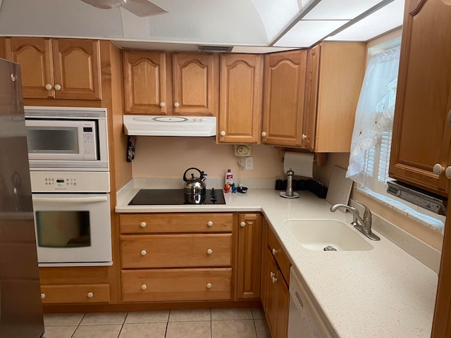 kitchen featuring ceiling fan, sink, white appliances, light stone countertops, and light tile patterned floors