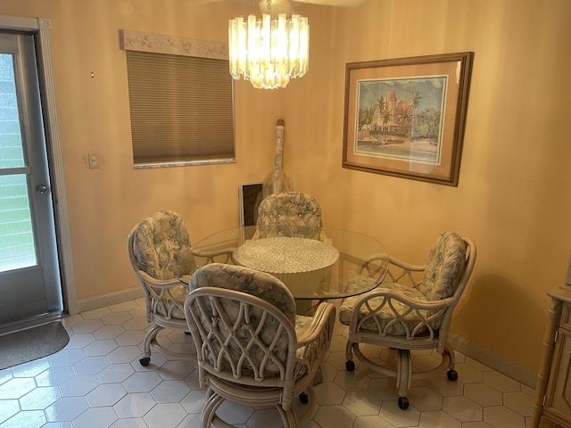 dining room with an inviting chandelier and light tile patterned floors