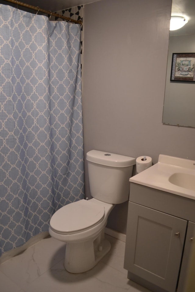 bathroom featuring tile floors, toilet, and vanity