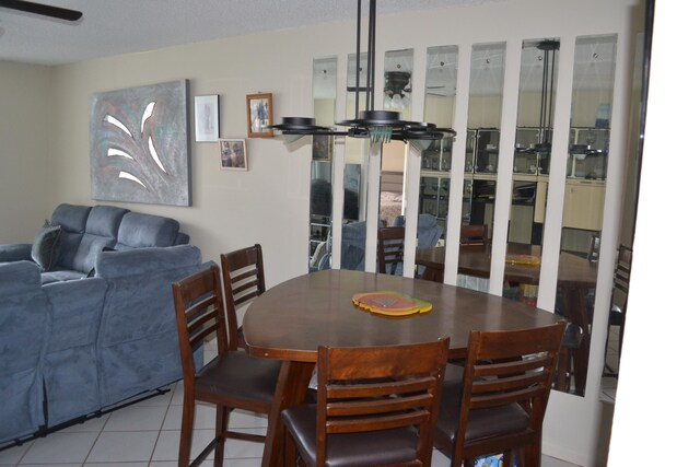 dining area featuring ceiling fan and light tile flooring