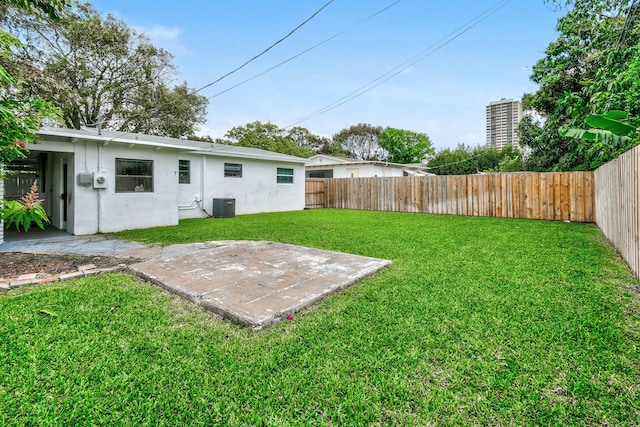 view of yard featuring central AC and a patio area