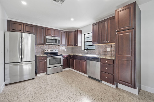 kitchen featuring backsplash, appliances with stainless steel finishes, dark brown cabinetry, and sink