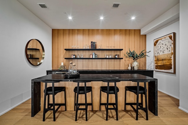 bar featuring light wood-type flooring