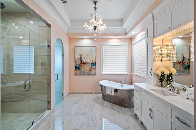 bathroom with a notable chandelier, separate shower and tub, and vanity