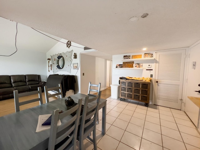 dining space with light tile flooring