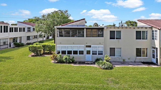 rear view of property with a yard