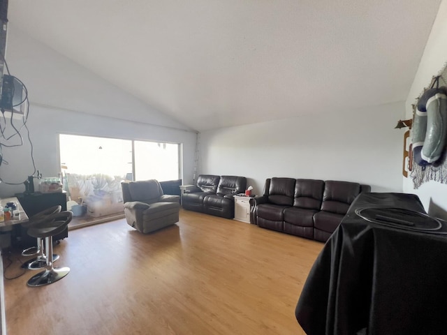 living room with wood-type flooring and high vaulted ceiling