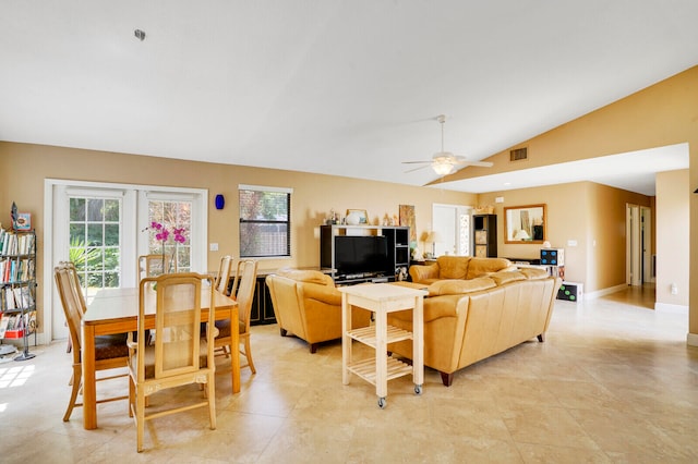 tiled living room featuring ceiling fan and lofted ceiling