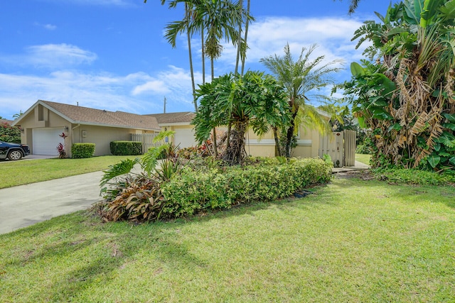 view of front of house with a garage and a front lawn