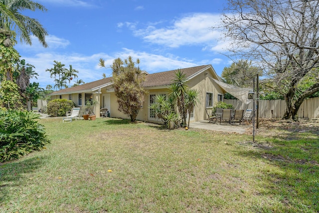 rear view of house featuring a lawn