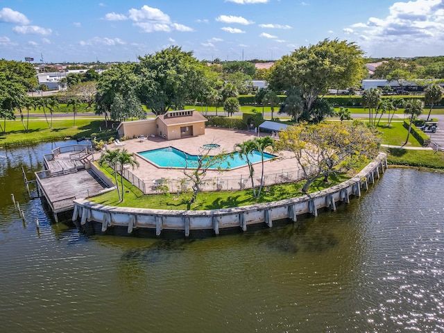 dock area featuring a water view and a fenced in pool