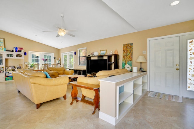 living room featuring lofted ceiling, ceiling fan, and light tile floors