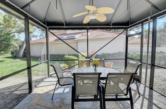 unfurnished sunroom featuring ceiling fan